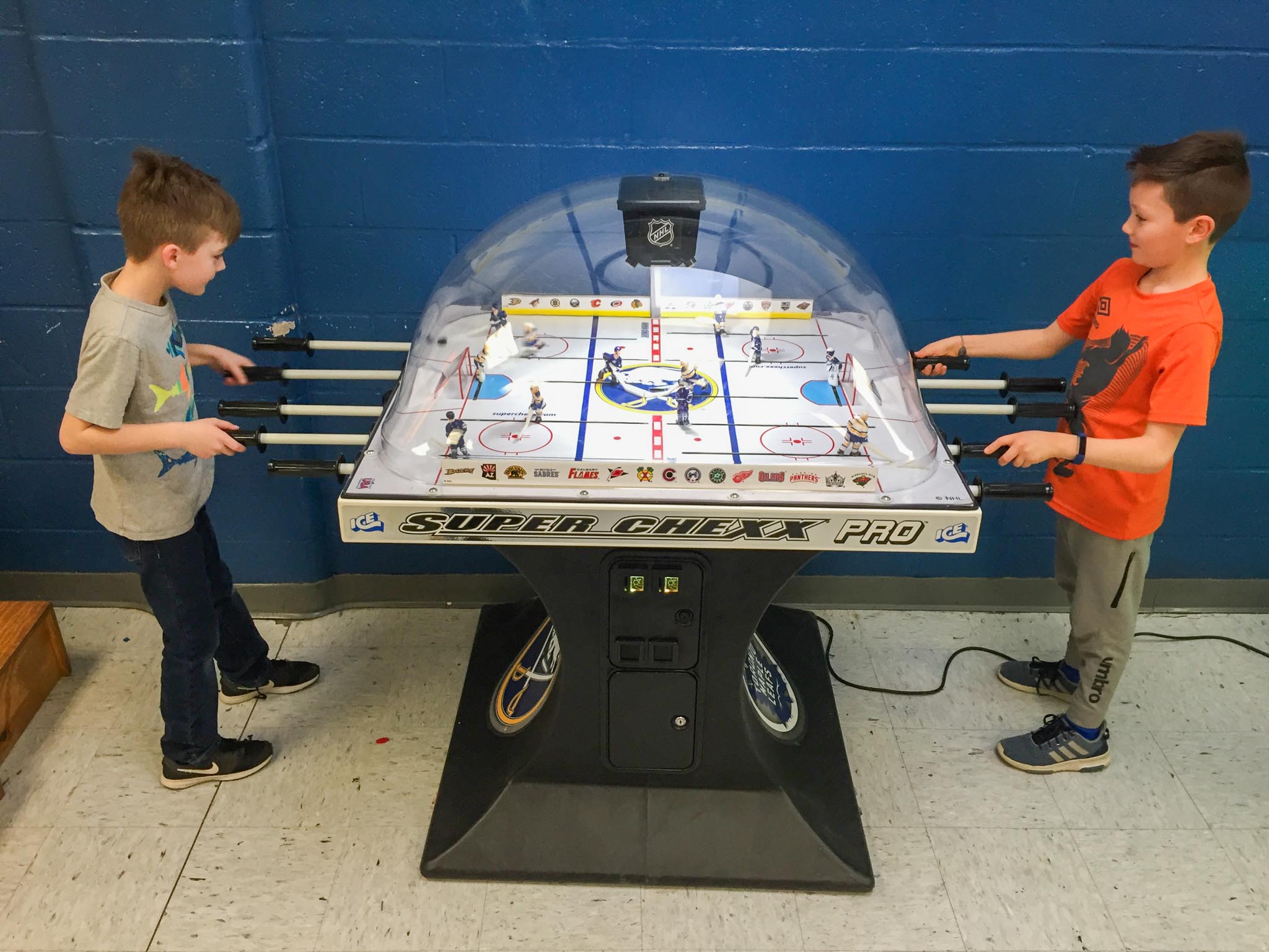 ICE Super Chexx Pro bubble hockey table, full cabinet, kids playing