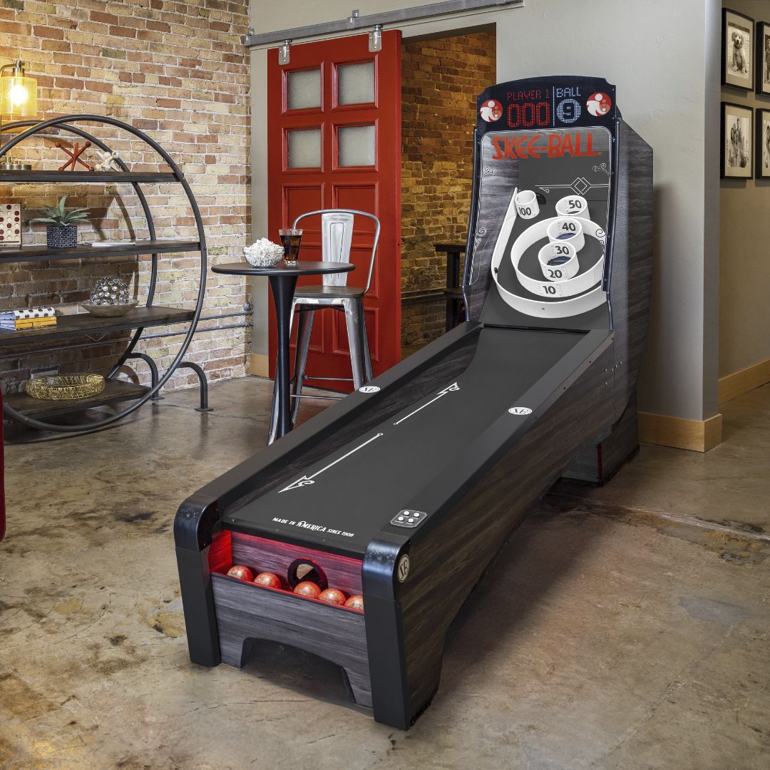 Skee-Ball Home Arcade Premium alley in a rec room, woodgrain cabinet and SKEE-BALL backglass